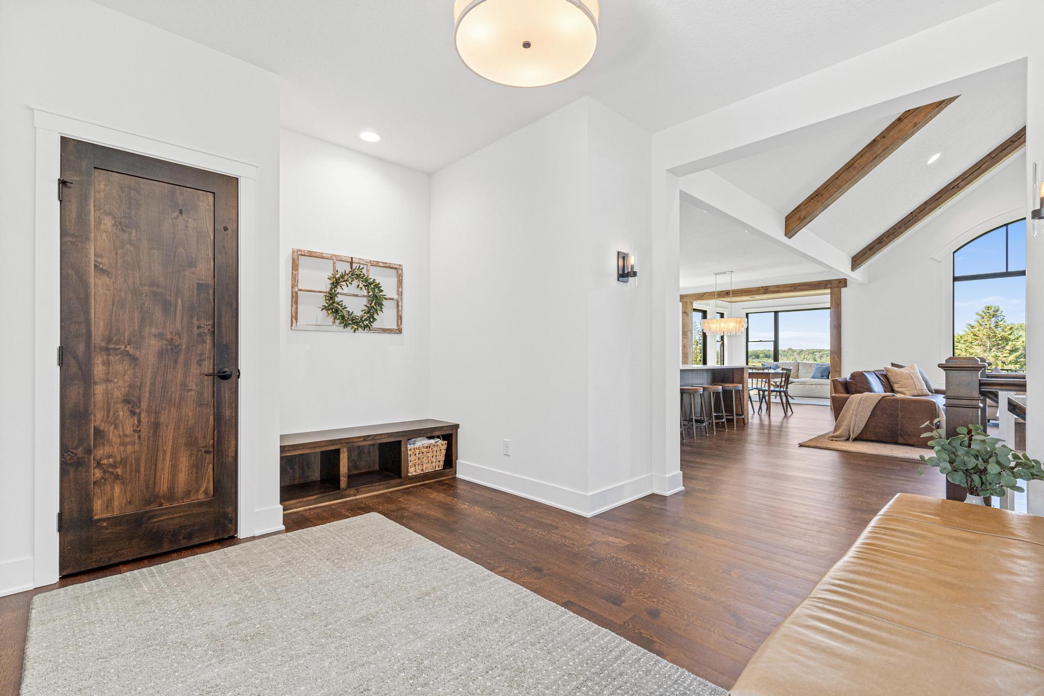 A warm and welcoming entry introduces the home's stunning craftsmanship, rich hardwood floors, and custom details.