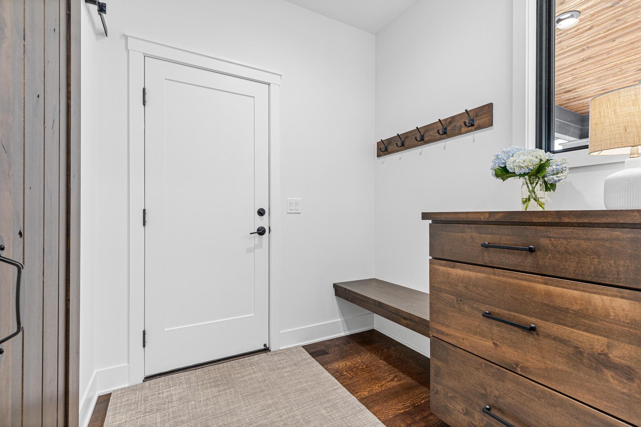 Large mudroom area with custom shelves and storage solutions.