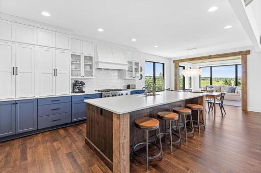 The heart of the home- a custom chef's kitchen featuring premium finishes, exceptional storage, and thoughtfully designed workspaces. Gather around the island for conversation, fun and food.