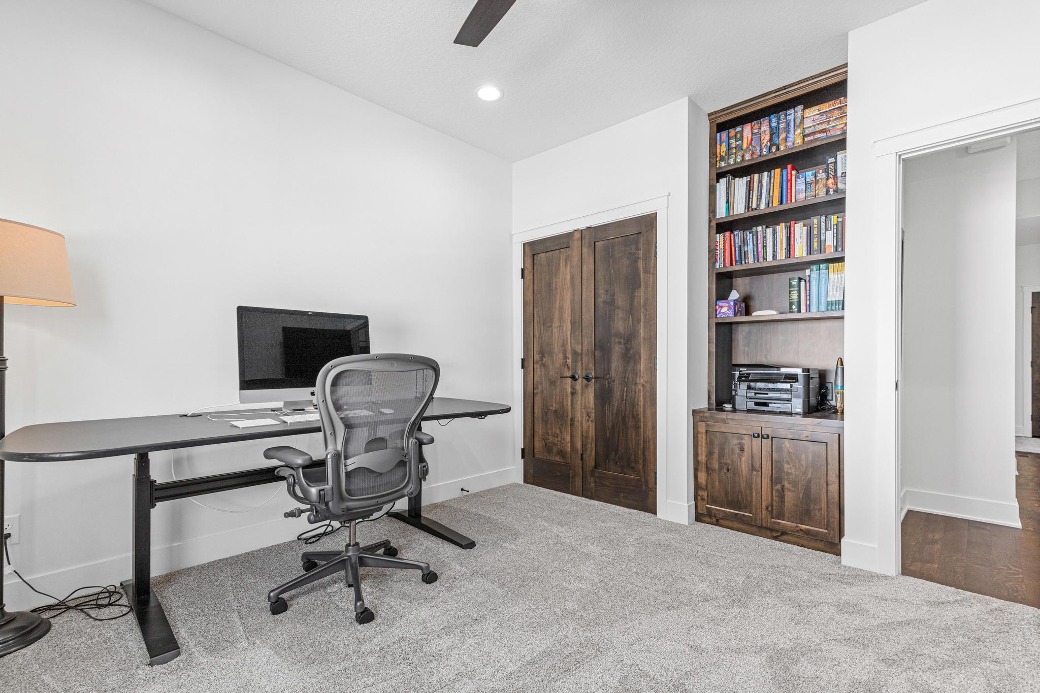 The second bedroom on the main level is currently being used as an office. Custom built-ins provide great storage for work materials.
