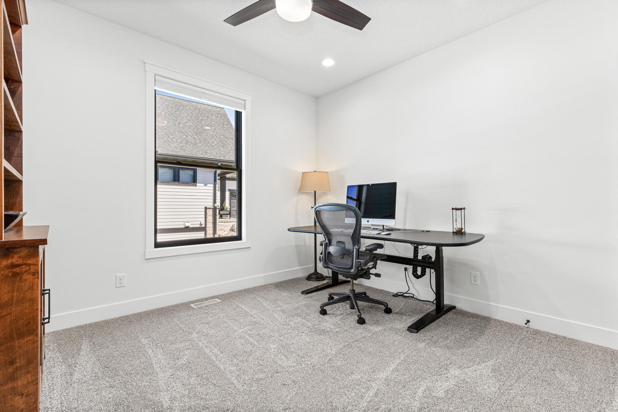 Privately tucked away from the main living areas, this bedroom/office provides the ideal work-from-home environment.