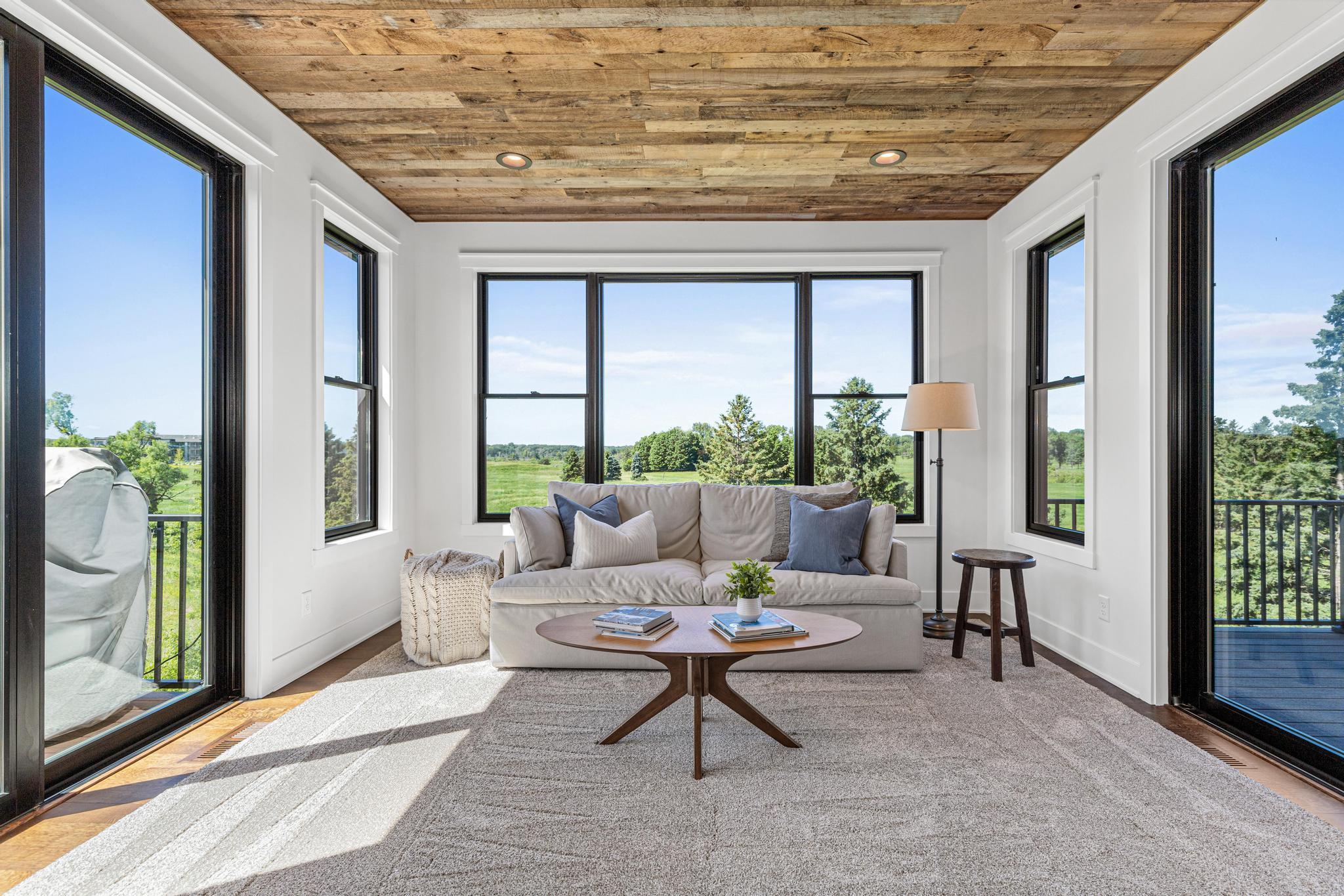Walls of glass bring the outdoors in while highlighting the home's craftsmanship and architectural details. The four- season porch will quickly become one of your favorite rooms in the home. Easy access to the grilling deck on the left.