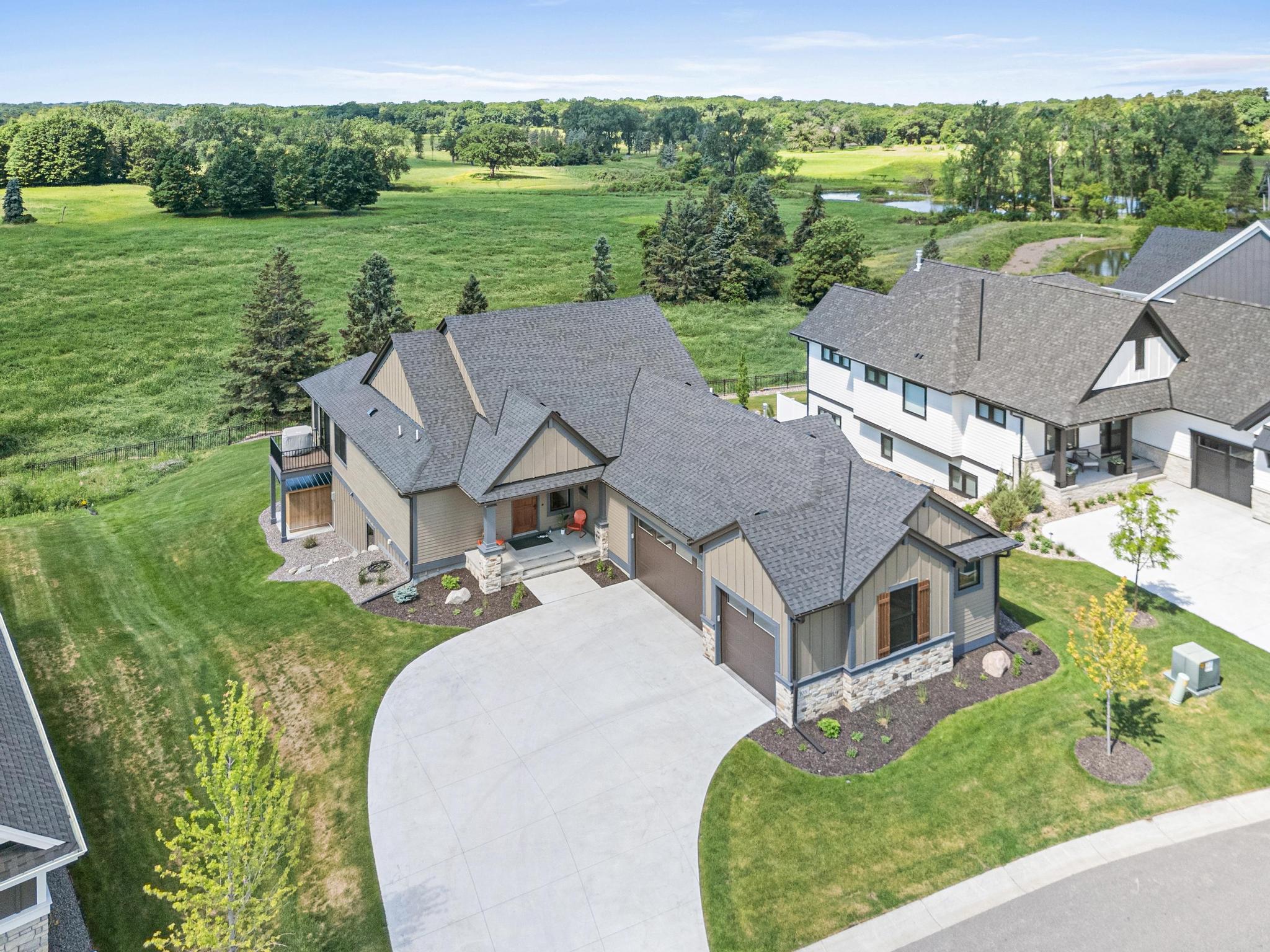 An extraordinary backyard setting with rolling green space, mature trees, and unmatched privacy.