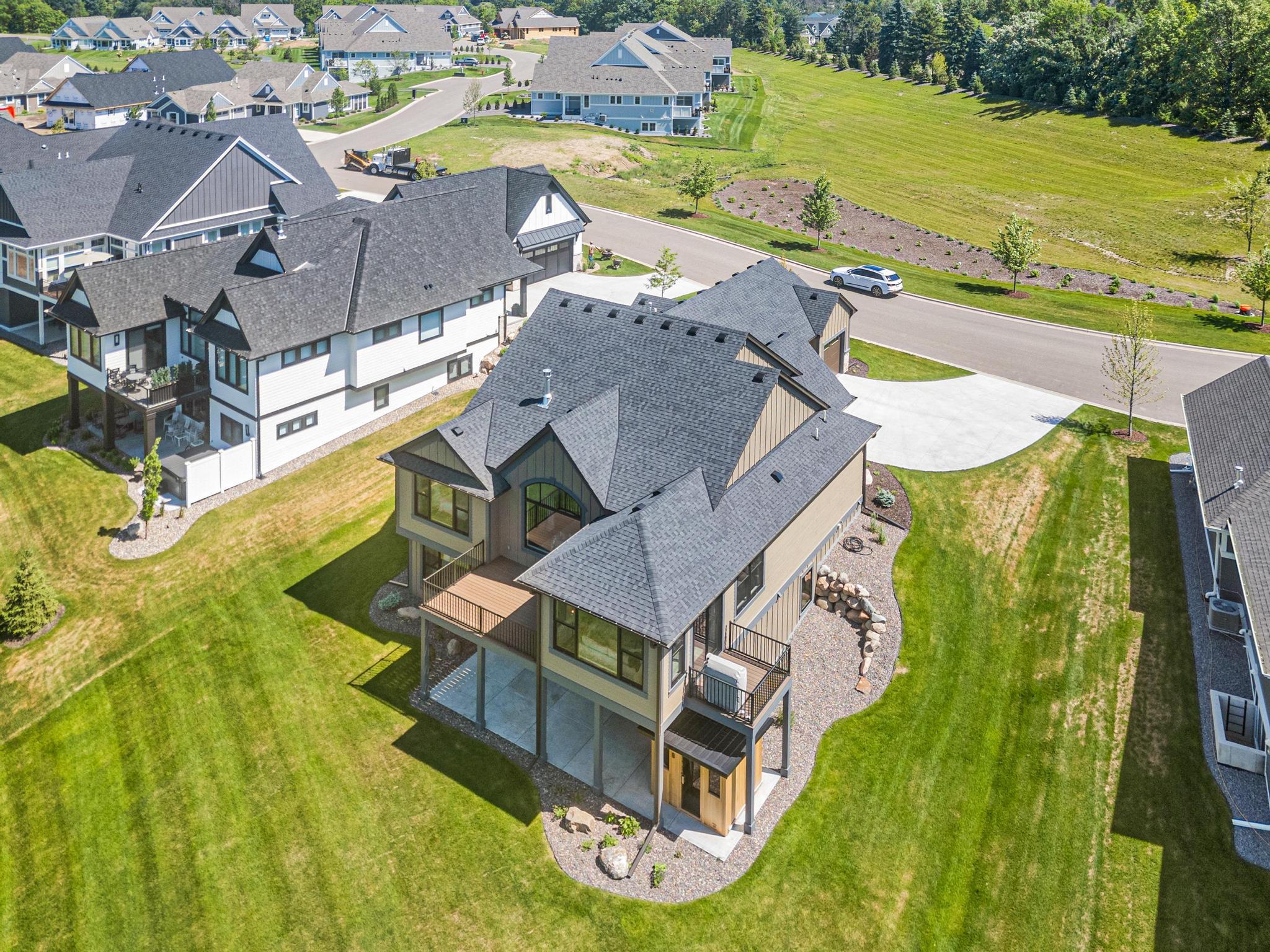 Aerial view showing the pretty green yard and open space on the front of the home. No neighbors to your east.