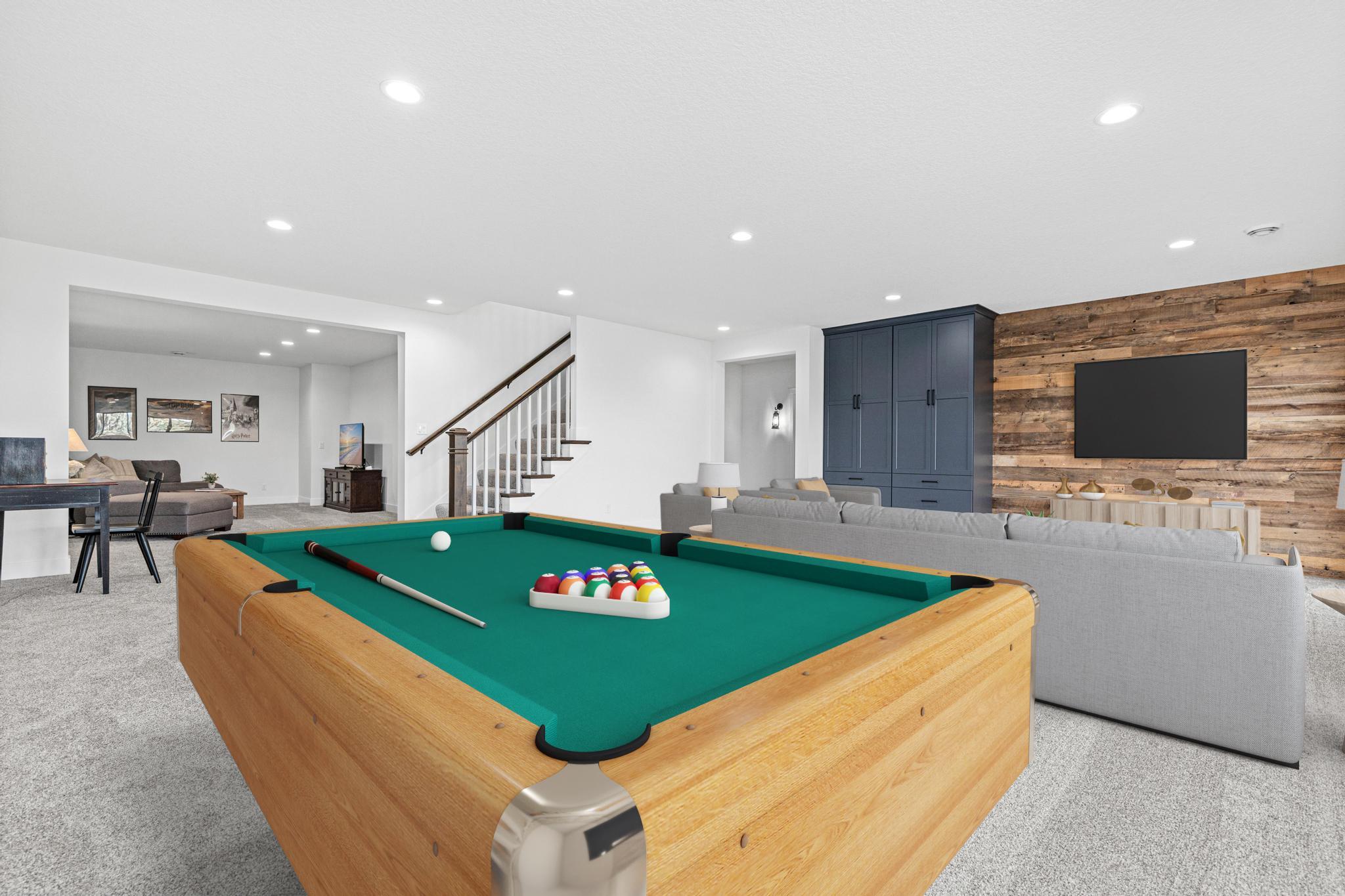 Oversized family room is the perfect place to watch the big game or your favorite movie. Space beyond is currently being used as a family/music room, but could be a great workout space or additional office. Virtually staged.