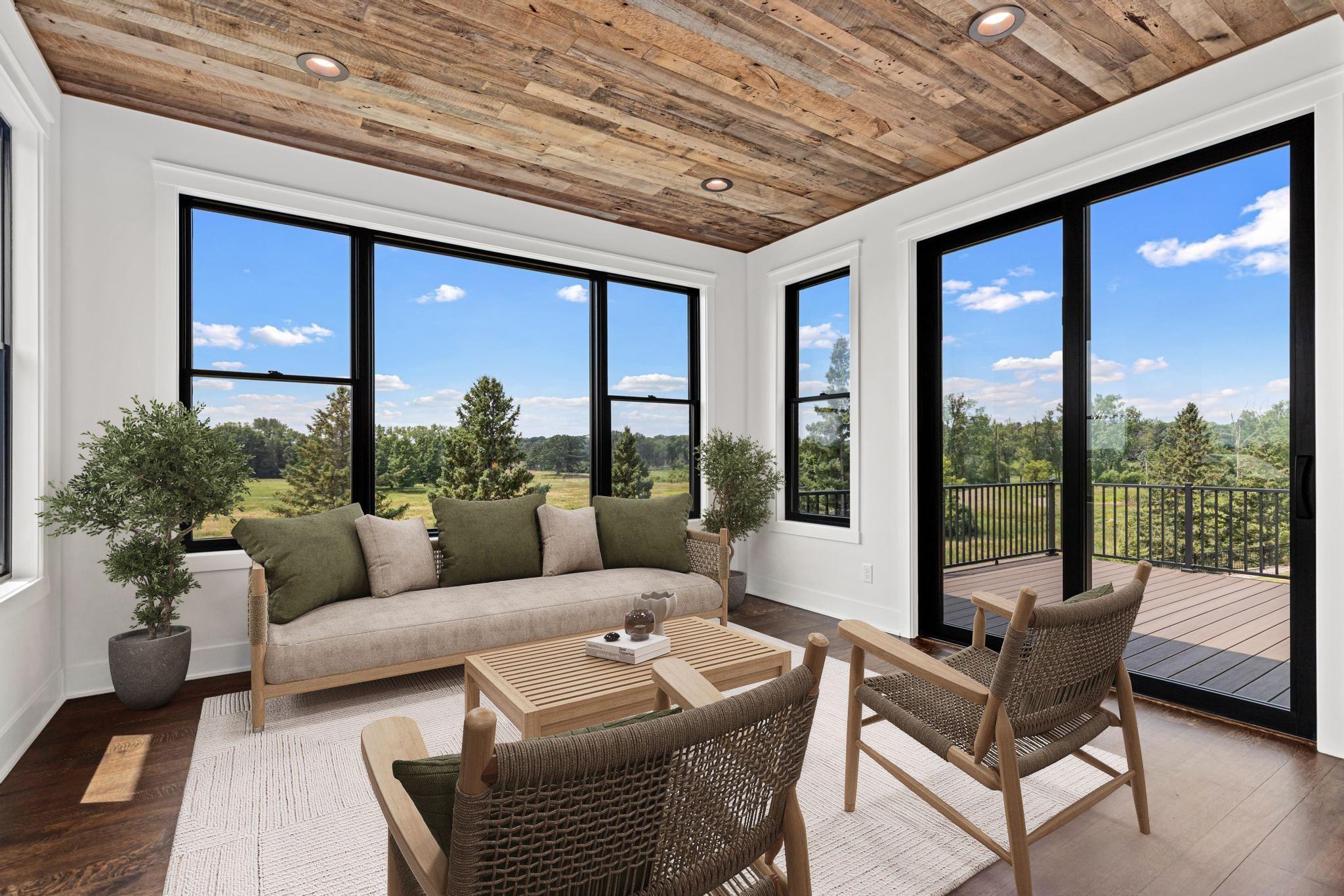 Walls of glass bring the outdoors in while highlighting the home's craftsmanship and architectural details. The four- season porch will quickly become one of your favorite rooms in the home. Visually staged.