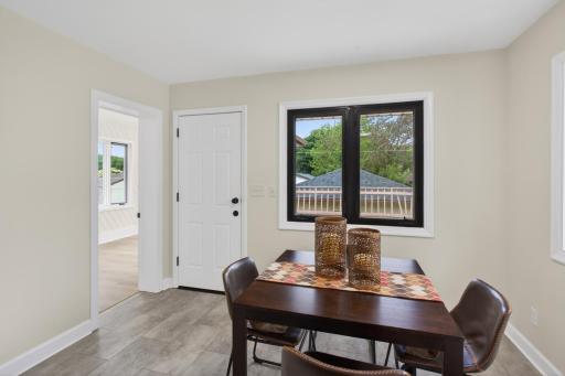 Main level: brand new kitchen and dining room area with quartz counters, stainless appliances, and new LVT flooring