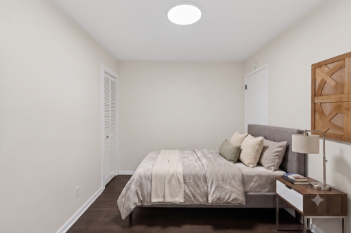 Main level: bedroom 3 - double doors open up to bonus family room next to the deck (virtually staged)