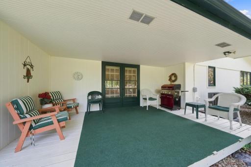 Conveniently covered patio overlooking the massive backyard