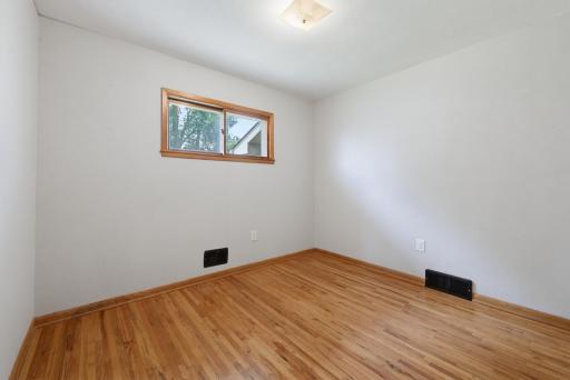 The second main floor bedroom. Beautiful oak hardwood floors are featured throughout the home.