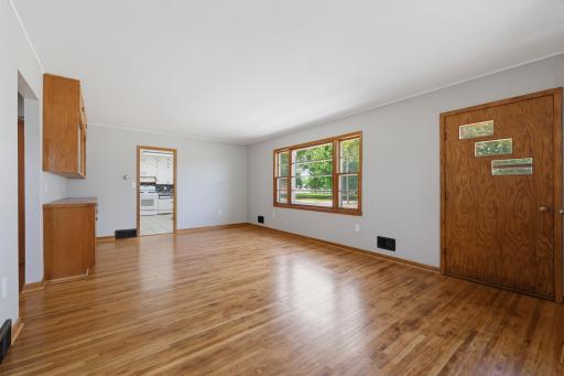 The living room features beautiful oak hardwood floors.