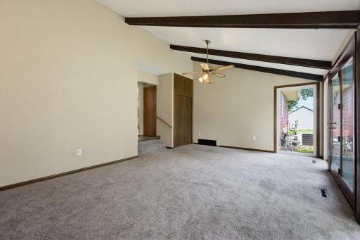 Another view of the spacious main floor family room with vaulted ceilings and new carpet.