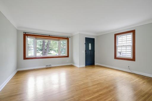 Living room features cove ceiling and large bay window for great natural light.