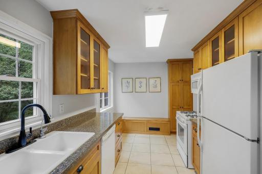 Reverse kitchen view looking towards eat-in area and wall pantry cabinet.