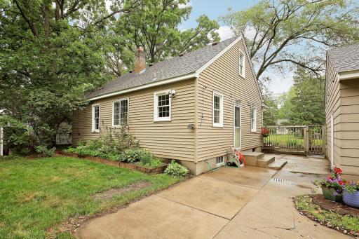 Additional rear view of home and timbered flowerbed area.