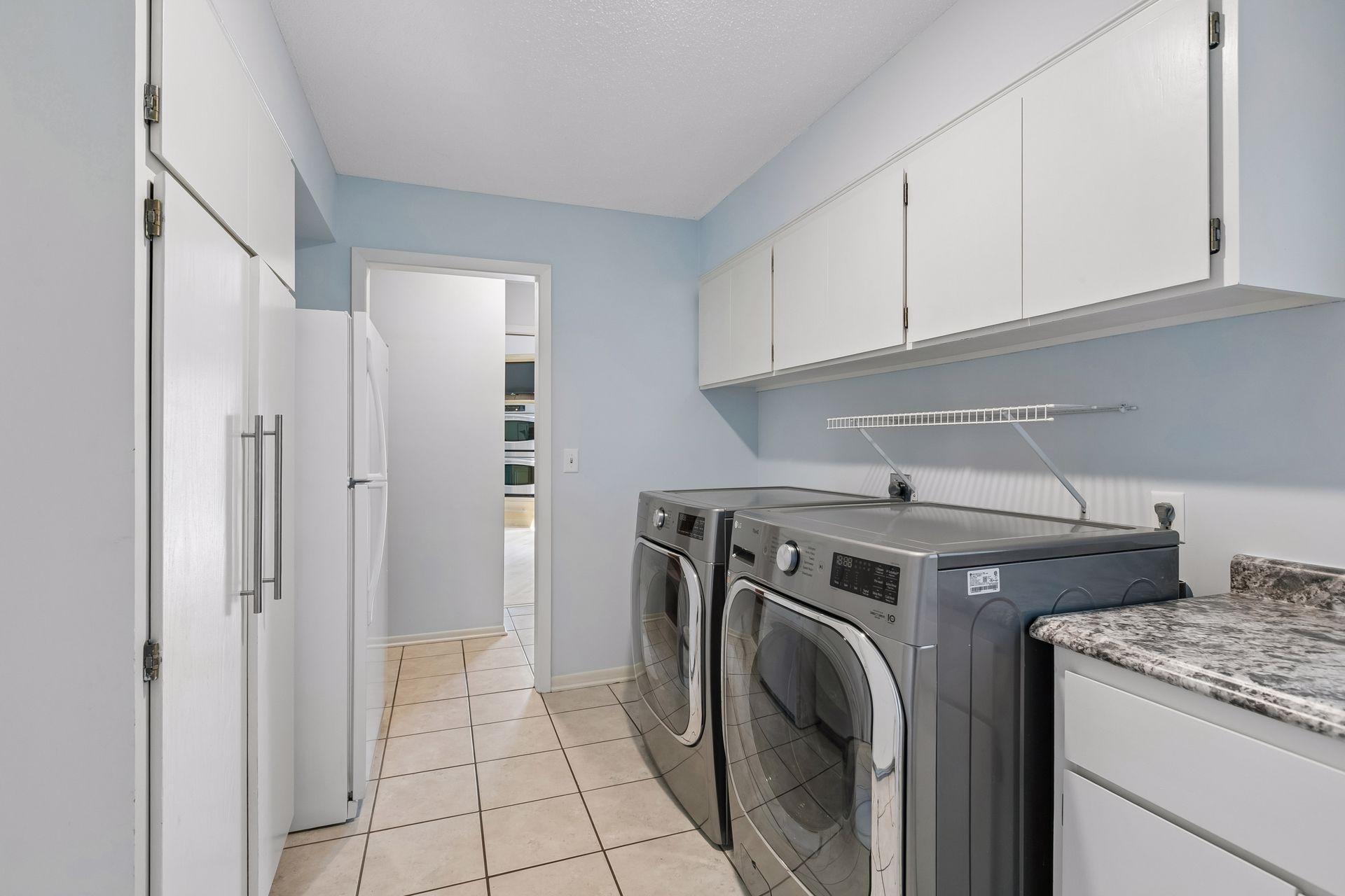 Conveniently located main-level laundry with ample storage.