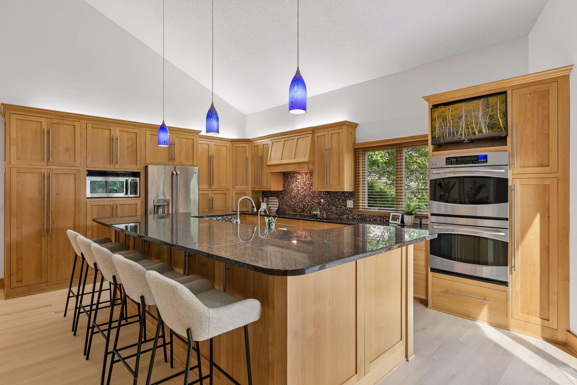 The chef’s kitchen offers a wonderful island and abundant storage and functionality.