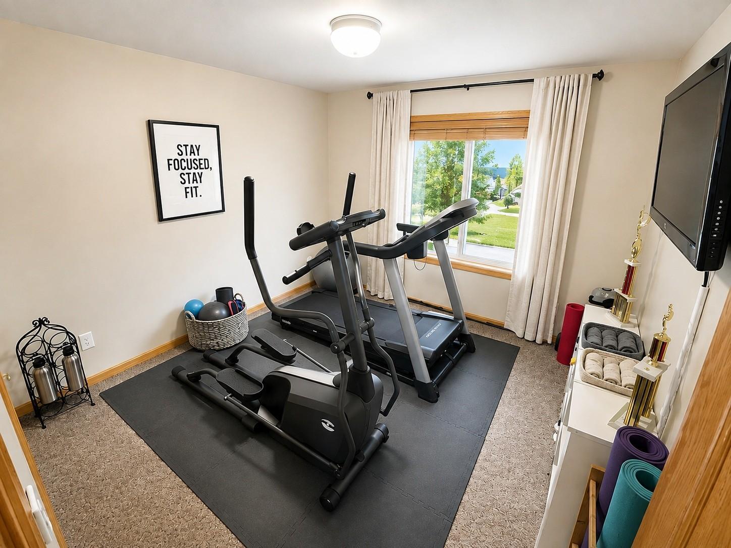 a_bright_well_lit_home_gym_room_photographed_from.jpg
