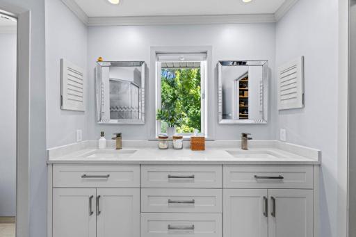 Dual vanities topped with beautiful HanStone countertops add both style and functionality to the luxurious ensuite bath.