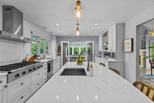 The kitchen offers direct access to the remarkable four-season porch, creating a seamless flow between indoor living and relaxation.
