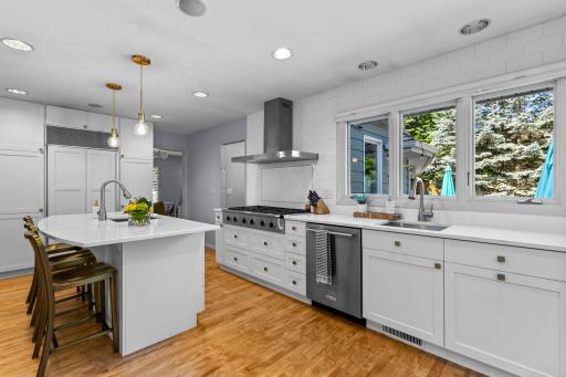 Equipped with premium stainless steel appliances, including a 48-inch Dacor gas cooktop, double oven, dishwasher, and exhaust fanâperfect for everyday living and entertaining.