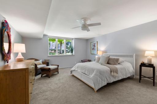 The lower level also includes a spacious fourth bedroom with carpeting and dual closets with built-ins.