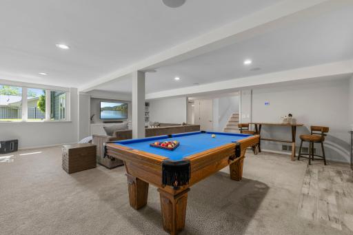 The lower level of the home is an entertainerâs dream, featuring an expansive family room and recreation area.