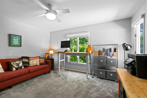 Bedroom three offers a spacious layout with ample closet space, a ceiling fan, and soft carpeting for added comfort.