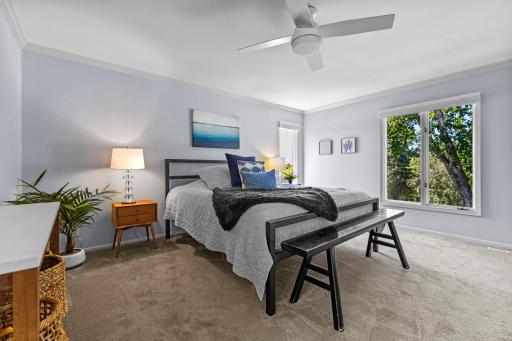 The upper level of the home offers three bedrooms, including a spacious primary suite.