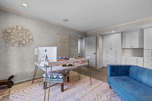 The office is enhanced with built-in cabinetry and drawers, providing exceptional storage and organization while adding both functionality and style.