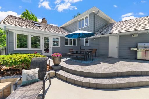 An alternate view of the patio highlighting its layered design, natural stone, and the seamless flow between each levelâperfectly suited for both relaxed outdoor living and elevated entertaining.