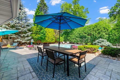 Elevated by an impressive terraced Fond du Lac stone patio, thoughtfully designed to create multiple outdoor living and entertaining zones while blending seamlessly with the surrounding landscape.
