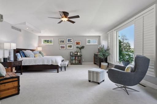 Wake up to lake views in the serene primary suite featuring a newly renovated bath and expanded closet.