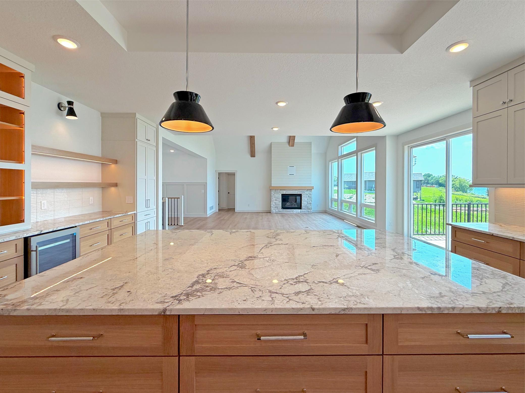 The oversized quartz island serves as the heart of the kitchen, offering generous preperation space, abundant storage, and wonderful comfortable seating for family and guests.