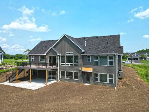 Expansive windows capture beautiful water views, while the spacious yard provides plenty of room for outdoor entertaining, games, and relaxation.