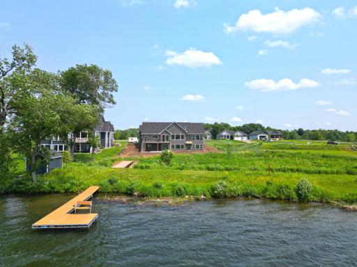 Newly completed and perfectly positioned on the water, this stunning lakeside home offers gorgeous views, and an unbeatable setting in one of the area's premier new neighborhoods.