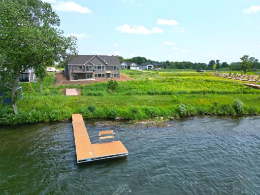 Enjoy a level backyard that gently leads to the water's edge, complete with a private dock ready for endless days on the lake.