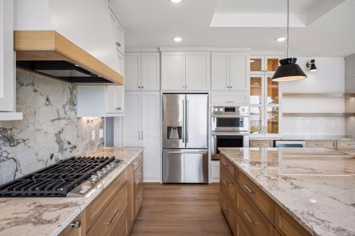 The oversized quartz island serves as the heart of the kitchen, offering generous preperation space, abundant storage, and wonderful comfortable seating for family and guests.