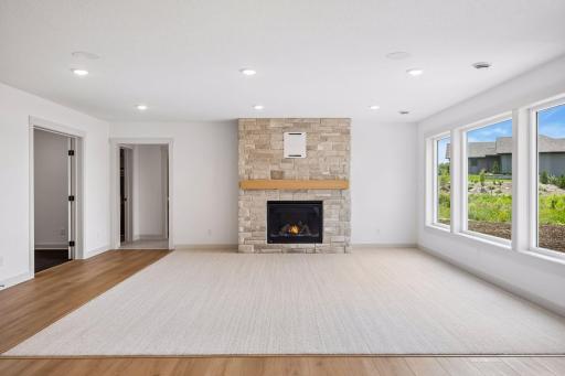 A beautiful floor-to-ceiling stone fireplace creates a warm focal point, making this spacious family room the perfect place to gather with family and friends year-round.
