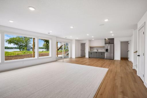 The walkout lower level is designed for entertaining, offering a spacious recreation area with easy access to the lakeside patio and beautiful views that bring the outdoors in.