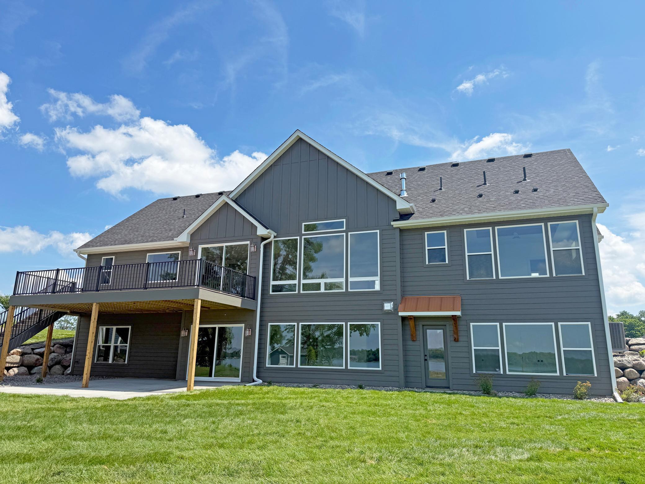 Expansive windows capture beautiful water views, while the spacious yard provides plenty of room for outdoor entertaining, games, and relaxation.