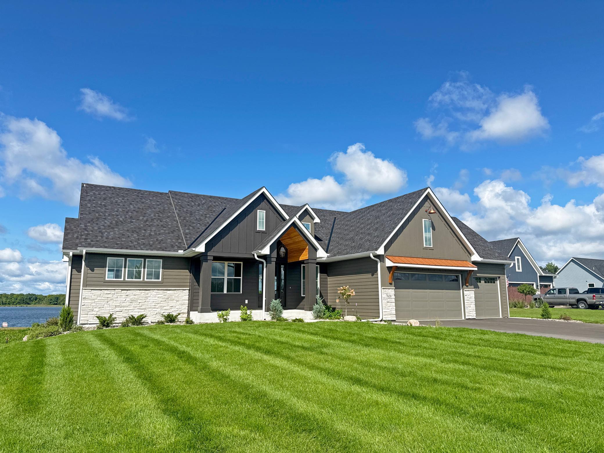 A covered entry welcomes you home and leads to a spacious main level designed with lake views in mind. Lush level lawn is calling your name!