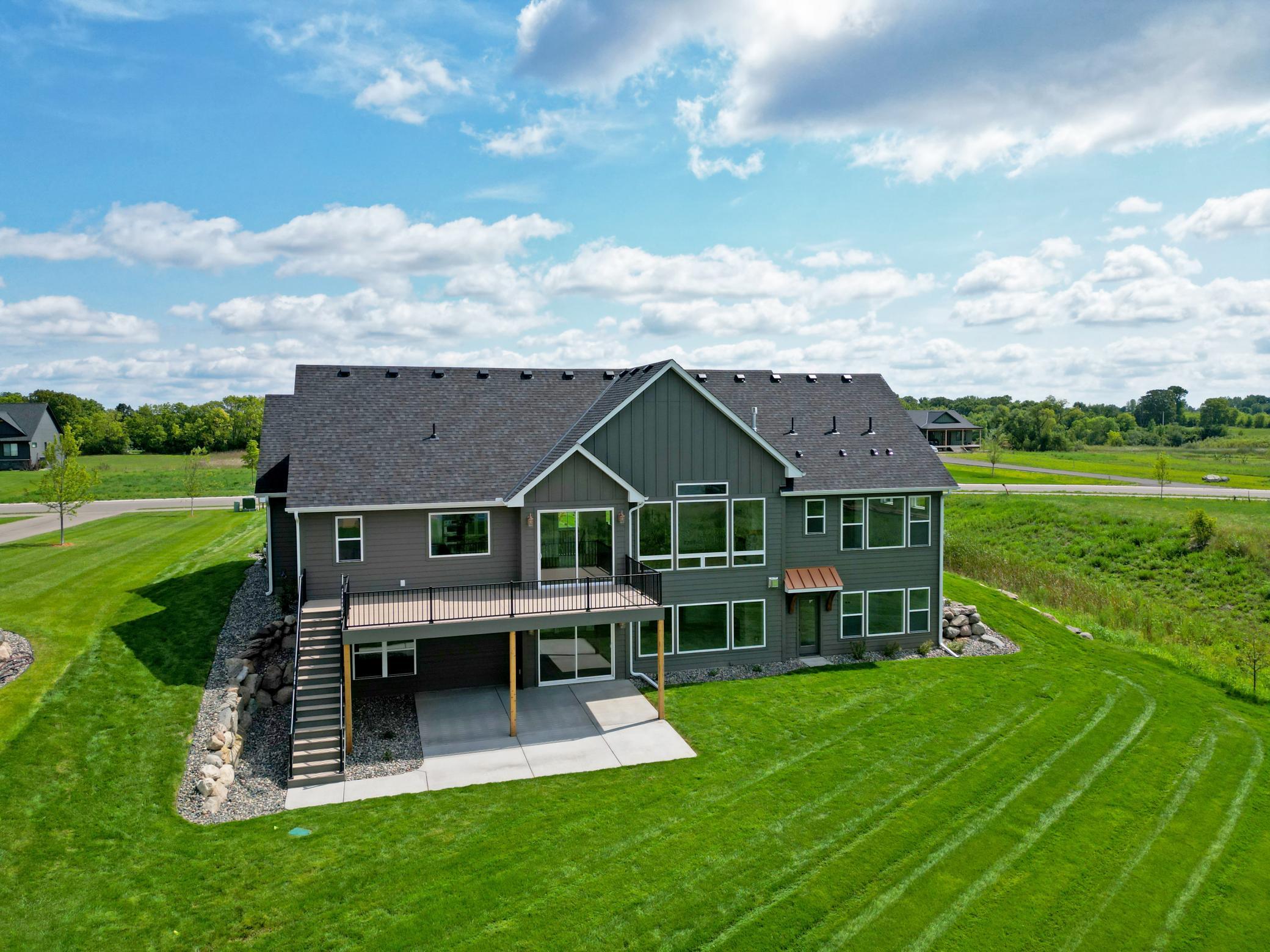 Expansive windows capture beautiful water views, while the spacious yard provides plenty of room for outdoor entertaining, games, and relaxation.