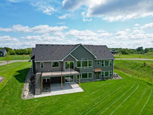Expansive windows capture beautiful water views, while the spacious yard provides plenty of room for outdoor entertaining, games, and relaxation.