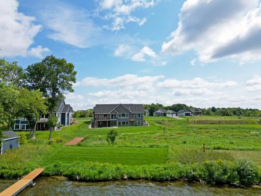 Enjoy a level backyard that gently leads to the water's edge, complete with a private dock ready for endless days on the lake.