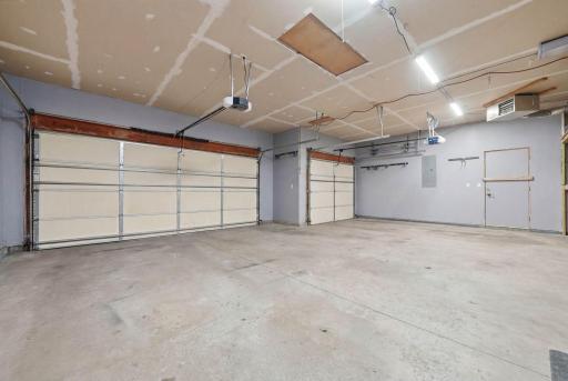 Attached insulated 3 stall garage (virtually staged).