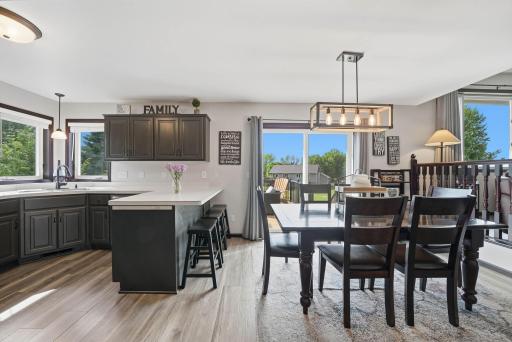 Kitchen also features a peninsula for extra seating. Kitchen flows nicely into the informal dining area. Informal dining area walks out to deck overlooking backyard.