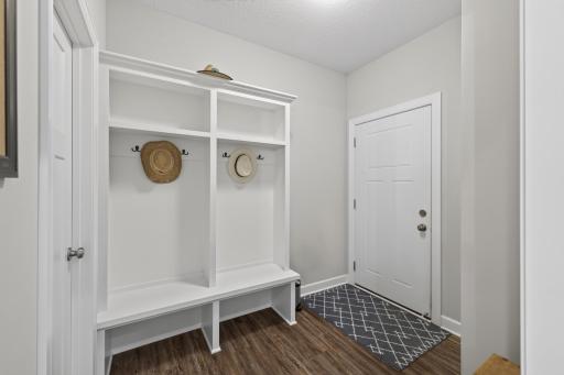 Dedicated mudroom off the garage with access to the walk-in pantry to the left.