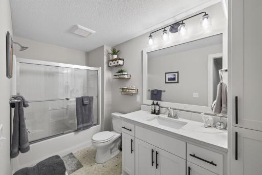 Lower-level full bath with vanity and tub/shower combination.
