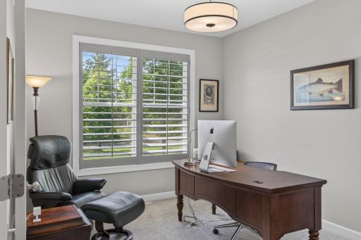 Dedicated office with French glass doors and plantation shutters.